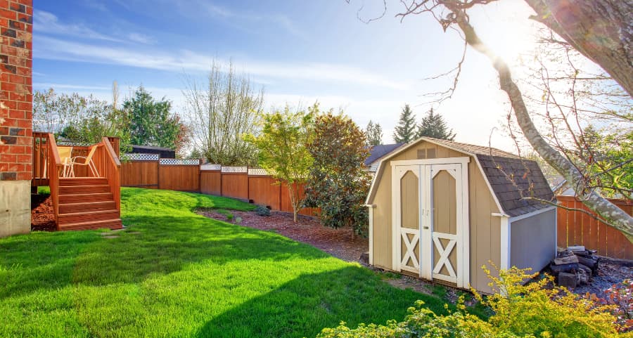 Fenced backyard with storage shed in Omaha